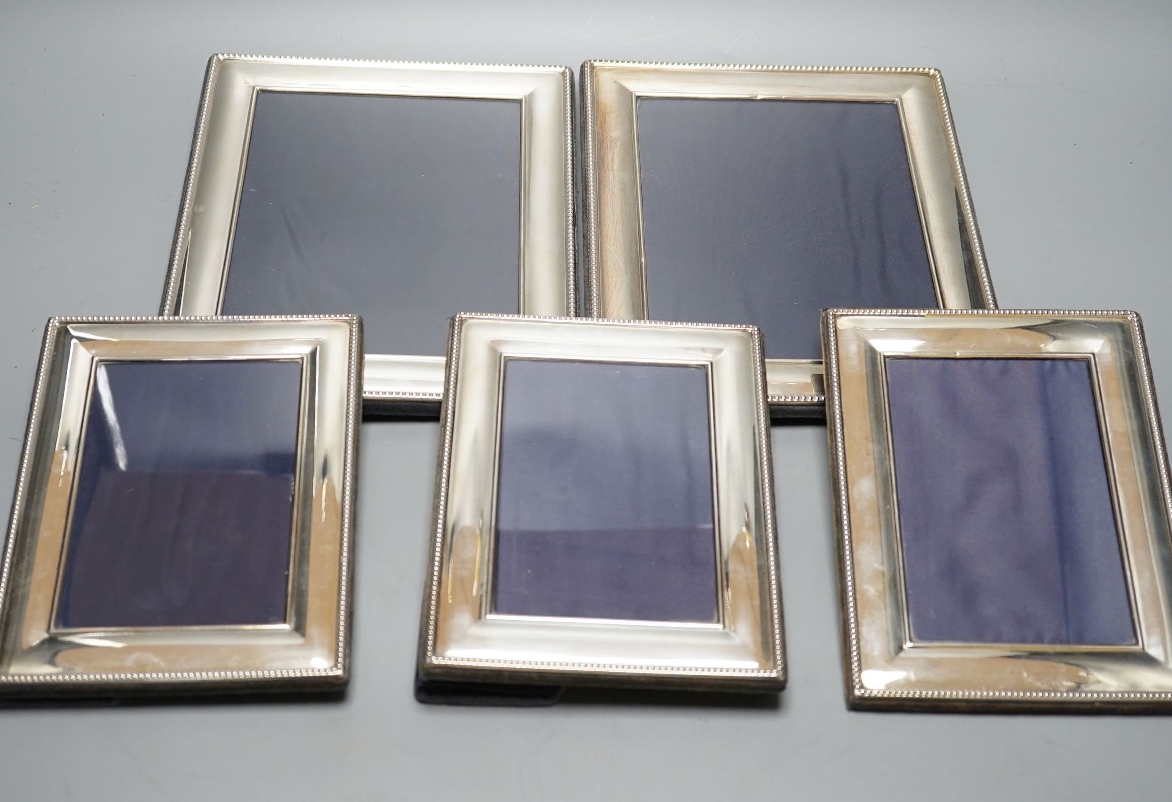 A modern pair of silver mounted photograph frames, Carrs of Sheffield, 2001, 26cm, and a set of three smaller frames, same maker, 2000, 20.2cm